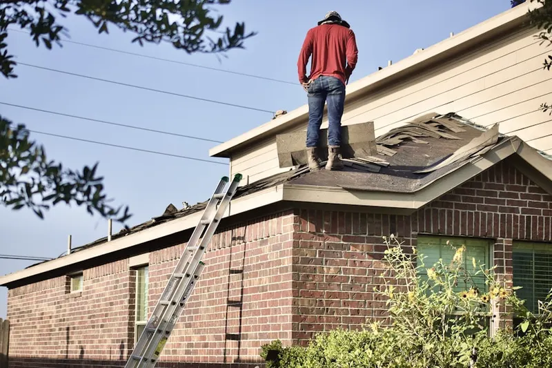 Professional roofer working on a residential roof in Cabin John